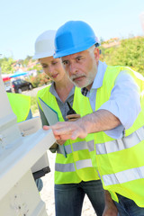 Construction workers checking building structure