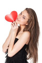 Portrait of young female in black dress holding heart shape