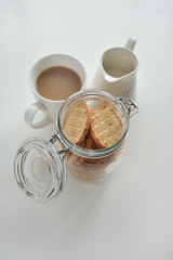 Cup of tea and jar of crackers