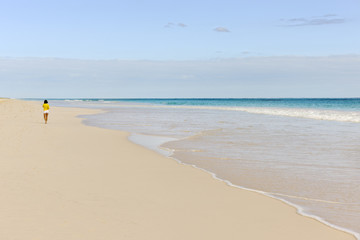 Woman jogging along the Pink Sands Beach on Harbour Island