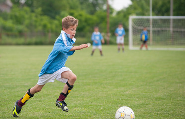 Obraz premium Little Boy playing soccer