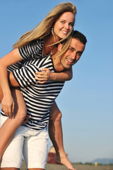 happy young couple have romantic time on beach