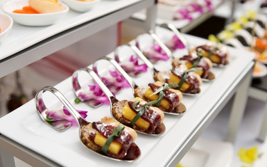 Canapes with cured ham on banquet table