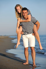 happy young couple have romantic time on beach