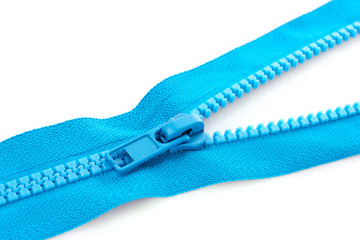 Blue zipper closeup isolated on white