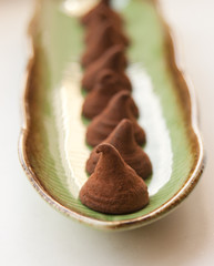 chocolate truffles on a green plate