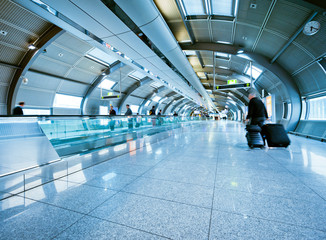 futuristic airport terminal with blurred passengers