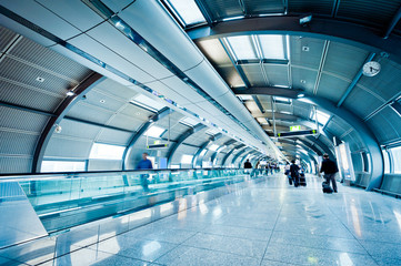 futuristic airport terminal with blurred passengers