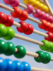 Close-up of a coloured children abacus in front of blue sky