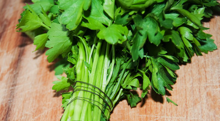 Bunch of fresh parsley on wooden background