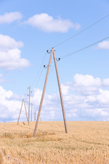 Fototapeta na wymiar Poles with wires in the box against the blue sky