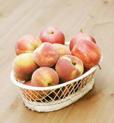 basket with peaches and apples