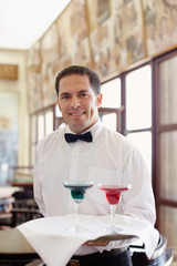 Obraz premium waiter standing with tray in restaurant