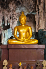 Golden buddha statue in the cave