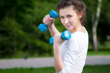 woman doing  exercise with dumbbell