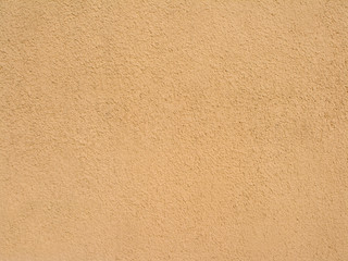 Abstract sandy brown plastered textured wall as background