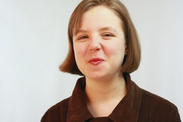 Young girl with puckered red lips and short brown hair.