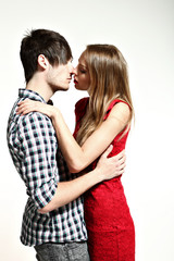 young couple kissing, studio portrait