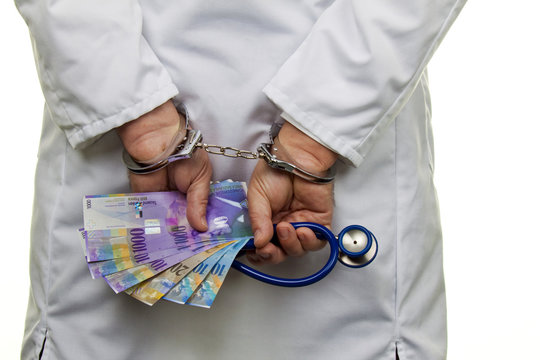 Doctors in Swiss francs notes and Handsc