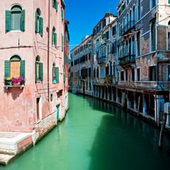 Beautiful venice canal with houses standing in water, Italy
