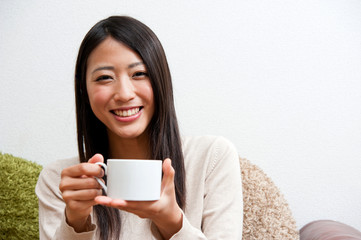 beautiful asian woman relaxing on the couch