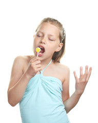 Cheerful little girl with lollipop singing