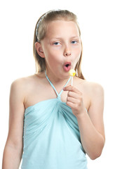 Cheerful little girl with lollipop singing