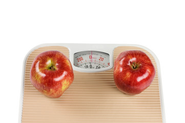 Scale and apple on white background
