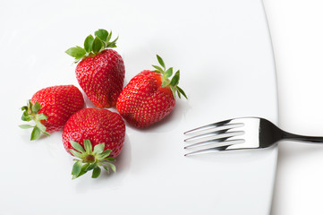 strawberries on plate with fork