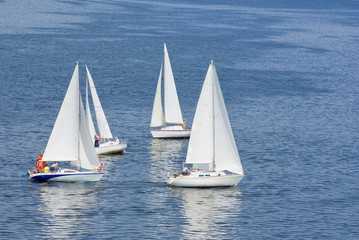 Fototapeta premium Four yachts making a close turn near buoy on a summer river.