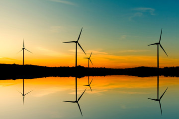 Windmills silhouette on suset background