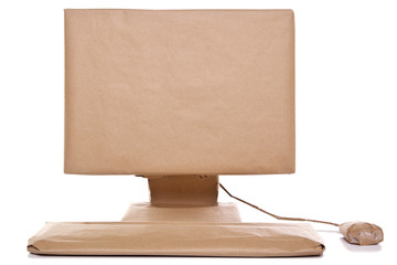 Computer wrapped in brown paper