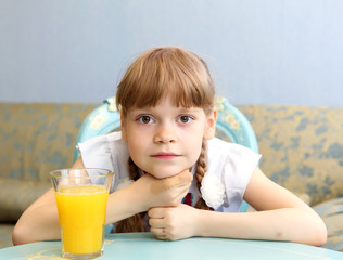 portrait of little girl with orange juice