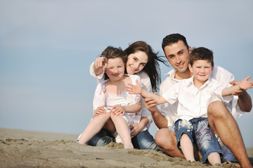 happy young family have fun on beach