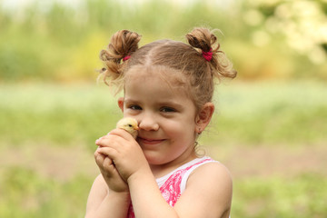 young girl holding little chicken