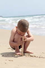Little boy playing on sand