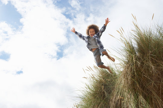 Boy Jumping Over Dune