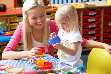 Young woman playing with girl