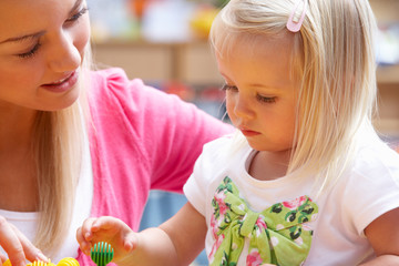 Young woman playing with girl