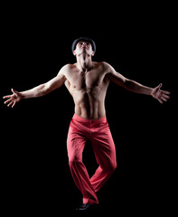 Fototapeta na wymiar young naked man dance striptease in red costume