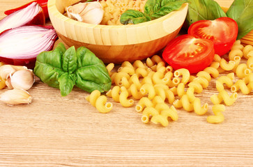 spaghetti with garlic, onion, spices  and basil on a yellow back