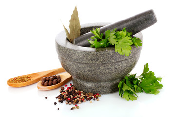 Mortar and pestle, parsley, bay leaf and pepper isolated on whit