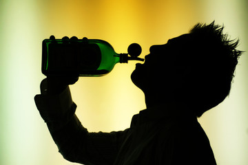 silhouette of drinking man on yellow green background