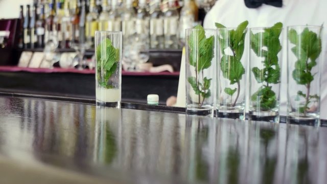 barman preparing mojito in pub
