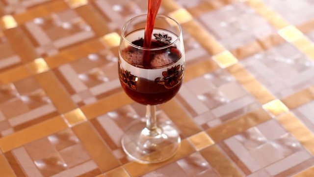 red fresh wine flowing to the bocal