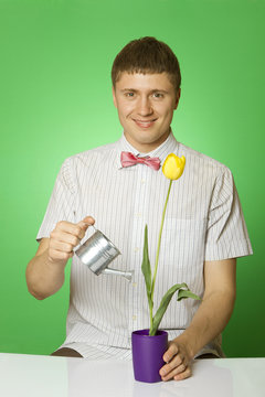 Parody lover man "nerd" watering tulip