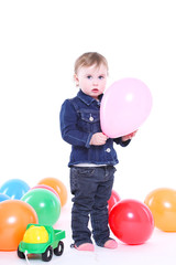 Fototapeta na wymiar little girl plays with color balloons