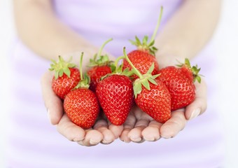 Girl with fresh strawberries