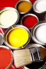 Cans of paint with paintbrush