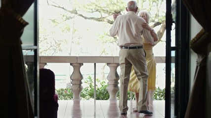 old man and woman dancing outdoor - Powered by Adobe